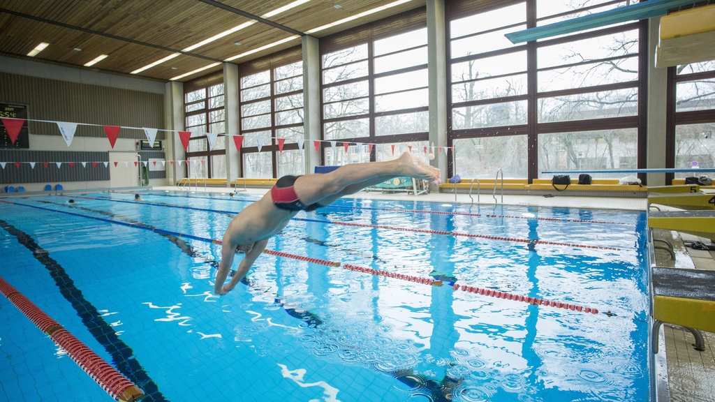 swimmer jumping in swimming pool
